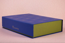Blue and green gift box with 'AAMRA' branding and gold foiling 